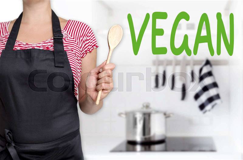 Vegan chef holding wooden spoon background, stock photo