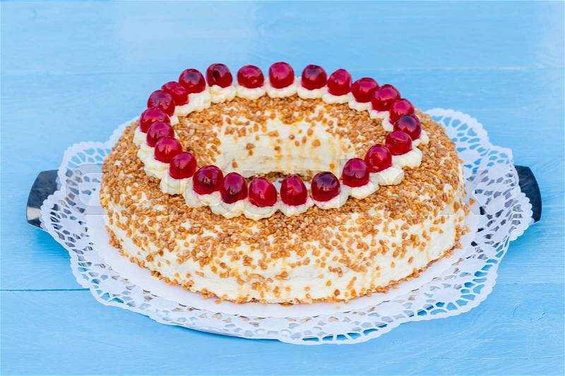 Frankfurt crown cake with cherries on a blue wood, stock photo