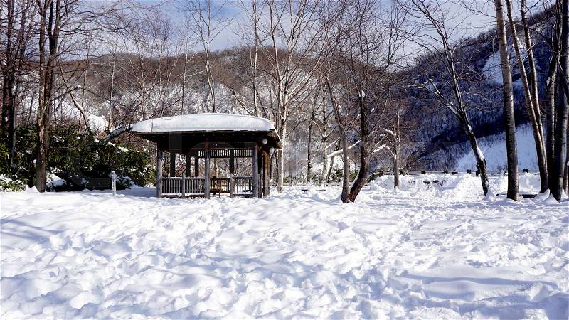 Snow and wooden pavilion landscape in the forest Noboribetsu onsen snow winter national park in Jigokudani, Hokkaido, Japan, stock photo