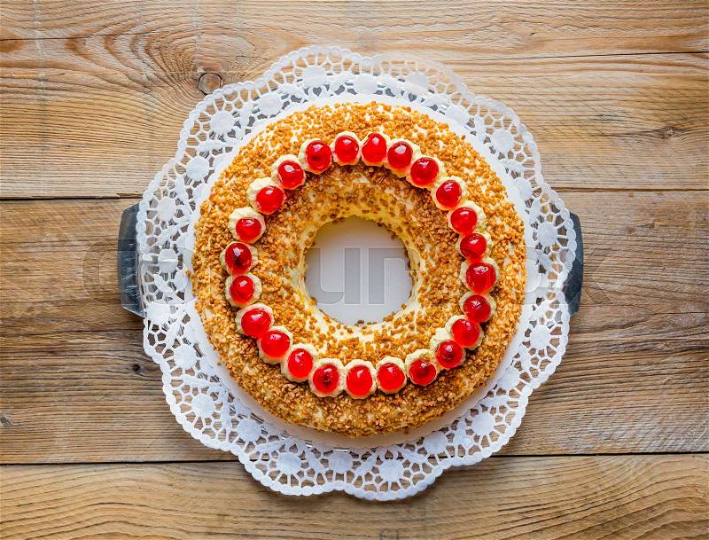 Frankfurt crown cake with cherries on rustic wood, stock photo
