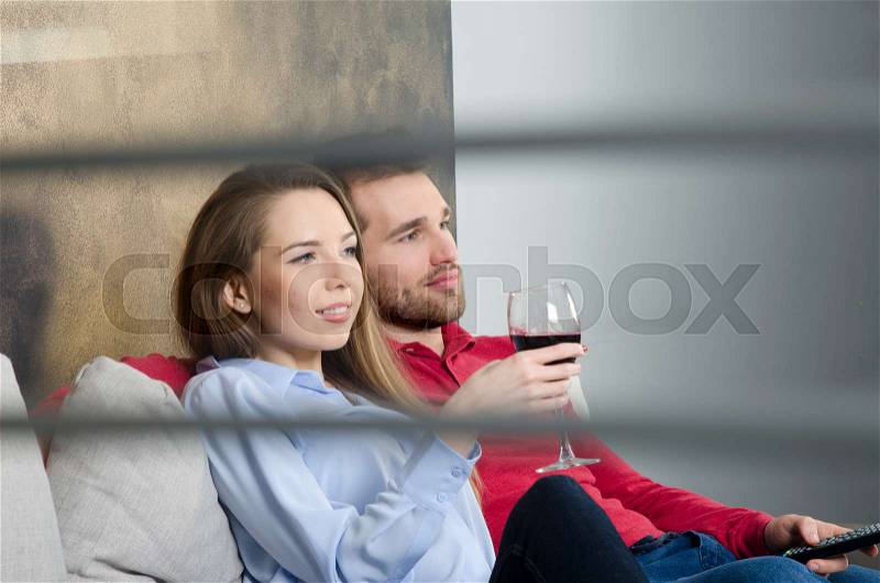 Couple enjoys free time and watching tv. couple leisure watching movie home fun tv room concept, stock photo