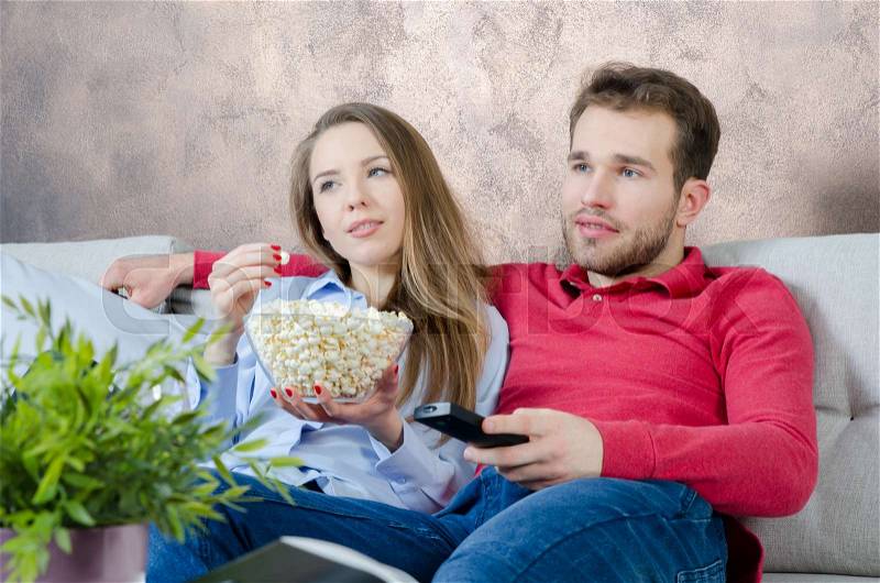Couple enjoys free time and watching tv. couple watching movie home fun watch tv room concept, stock photo