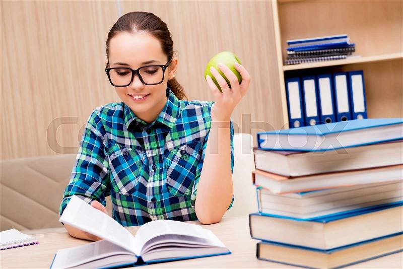 Young female student preparing for exams, stock photo