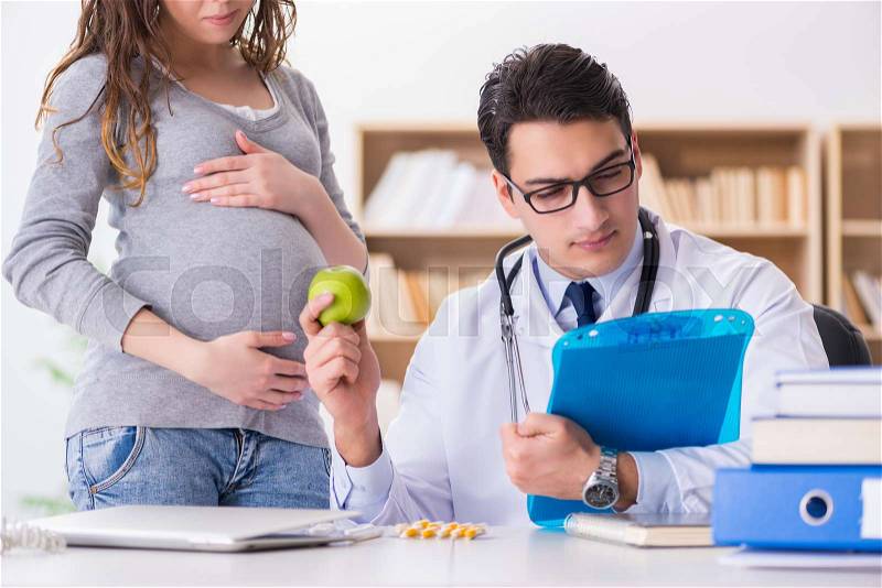 Pregnant woman visiting doctor for consultation, stock photo