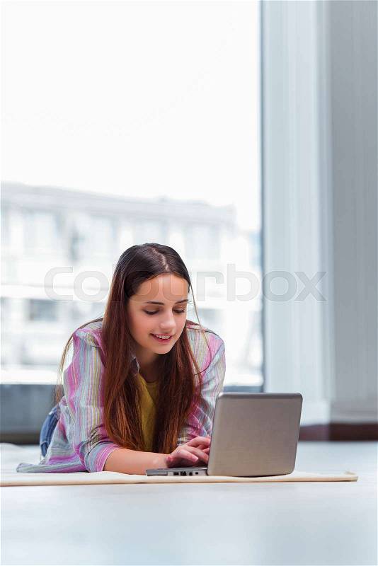Young girl surfing internet on laptop, stock photo