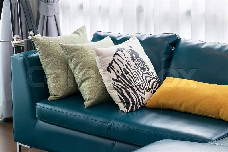 Modern living room with green sofa and pillows at home, stock photo