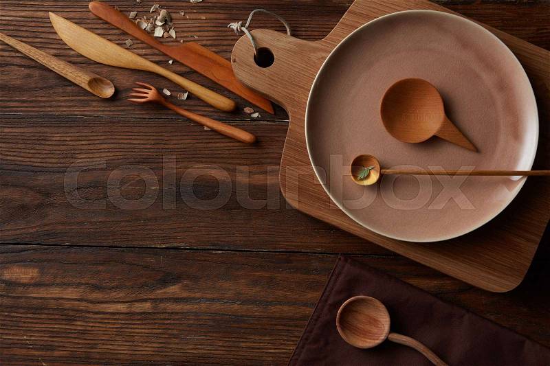 Rural vintage wood kitchen table with cooking utensils around, stock photo