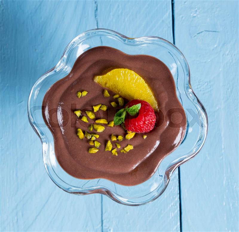 Chocolate pudding dessert with orange and pistachio, stock photo