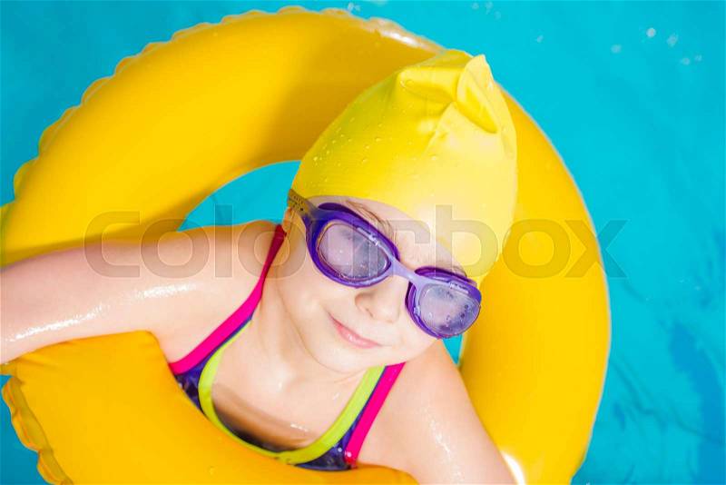 Little Caucasian Girl Learn to Swim in the Swimming Pool. Closeup Photo, stock photo