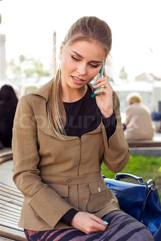 Business woman speak on phone near big park outdoor, stock photo