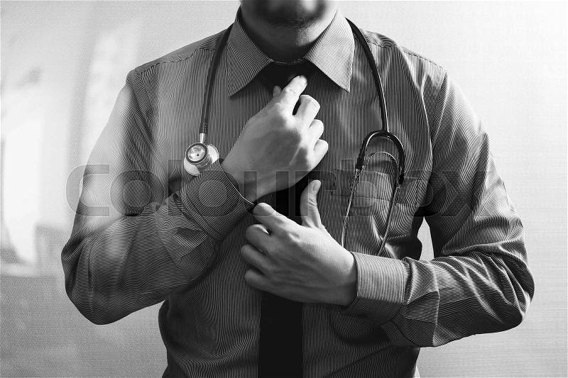 Smart medical doctor holding digital tablet computer,stethoscope ,front view,filter effect,black white, stock photo