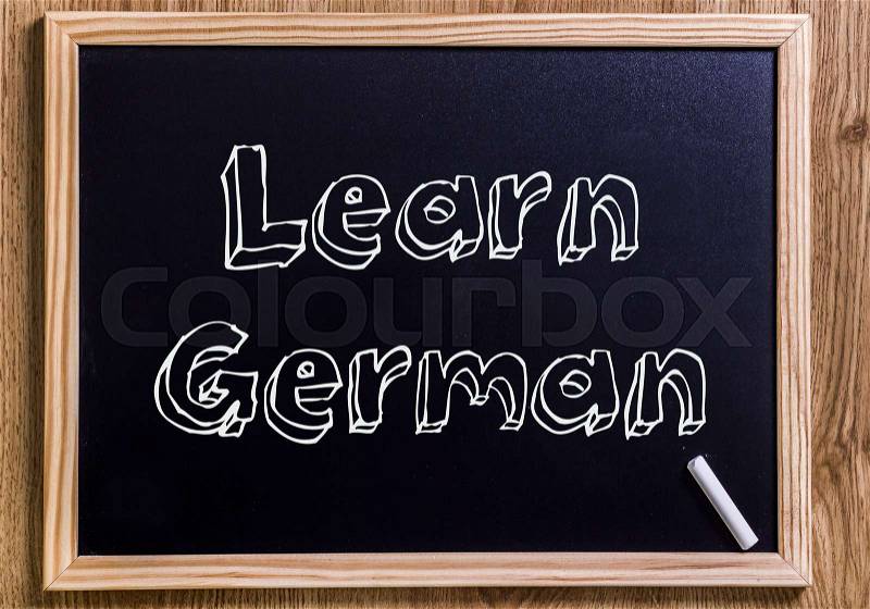 Learn German - New chalkboard with outlined text - on wood, stock photo