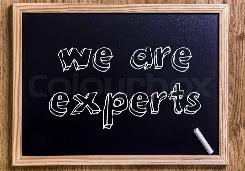 We are experts - New chalkboard with 3D outlined text - on wood, stock photo