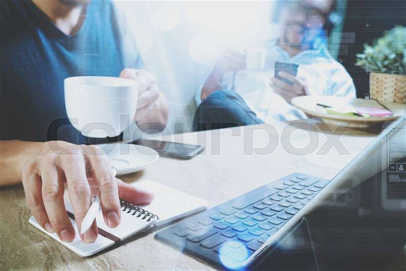 Co working website designers working at office and holding a cup of coffee,working on smart phone and digital tablet computer docking on smart keyboard,filter film effect , stock photo