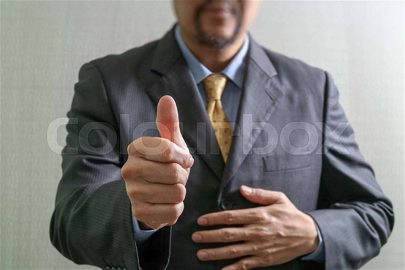 Businessman with his thumb up Front view, no head. Concept of working in an office, stock photo