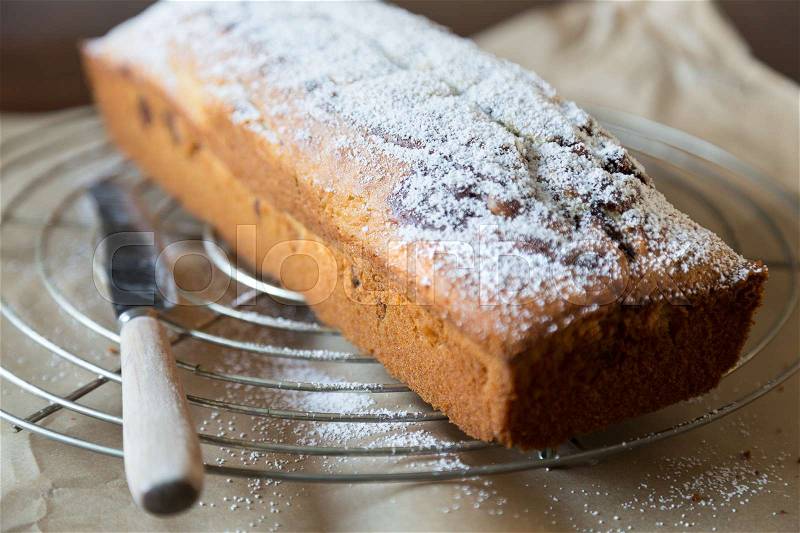 Powdered sugar is applied to marble cake , stock photo