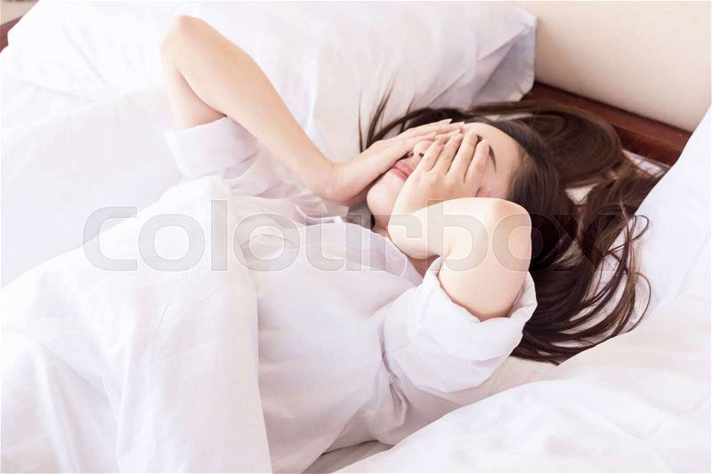 Young woman can not sleep. on her bed and thinking, stock photo