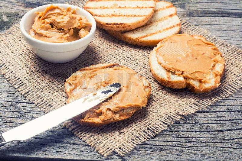 Peanut butter sandwich on rustic wooden background, stock photo