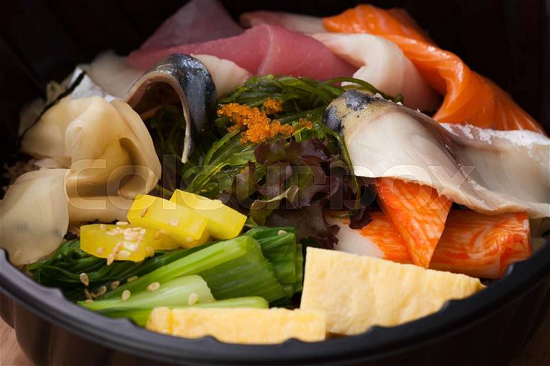 Japanese food Tekka Don take away on wooden background raw tuna salmon otoro seaweed rice, stock photo