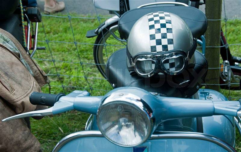 Old helmet and blue motorbike, stock photo