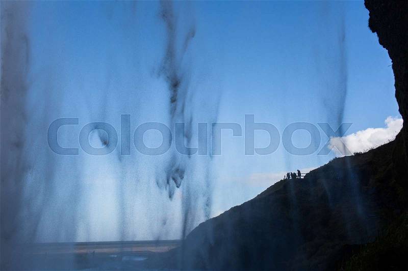 Cascade of water falling from cliff, stock photo