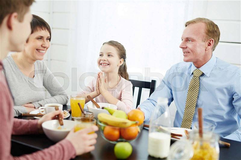 Family eating organic food by breakfast, stock photo