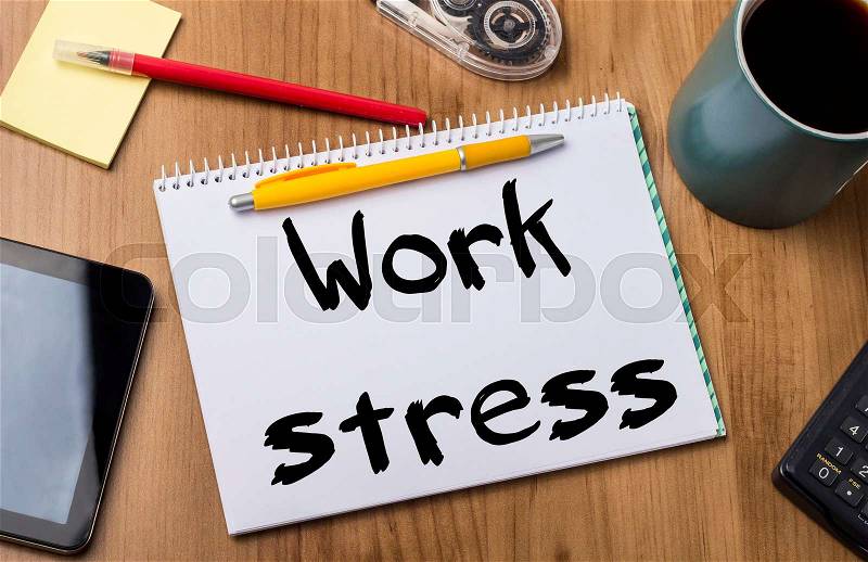 Work stress - Note Pad With Text On Wooden Table - with office tools, stock photo