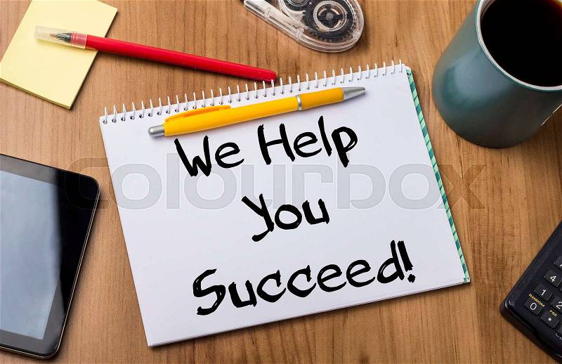 We Help You Succeed! - Note Pad With Text On Wooden Table - with office tools, stock photo