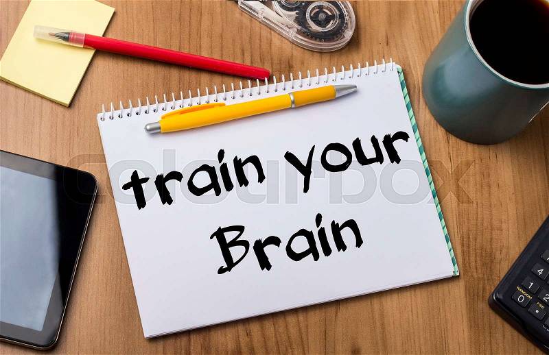 Train your Brain - Note Pad With Text On Wooden Table - with office tools, stock photo