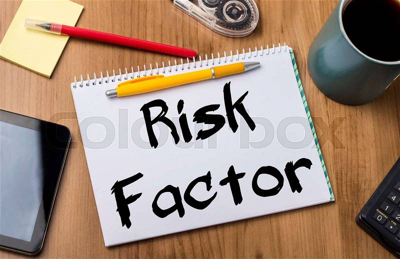 Risk Factor - Note Pad With Text On Wooden Table - with office tools, stock photo