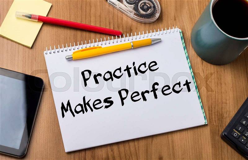 Practice makes Perfect - Note Pad With Text On Wooden Table - with office tools, stock photo