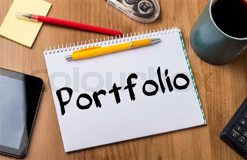 Portfolio - Note Pad With Text On Wooden Table - with office tools, stock photo