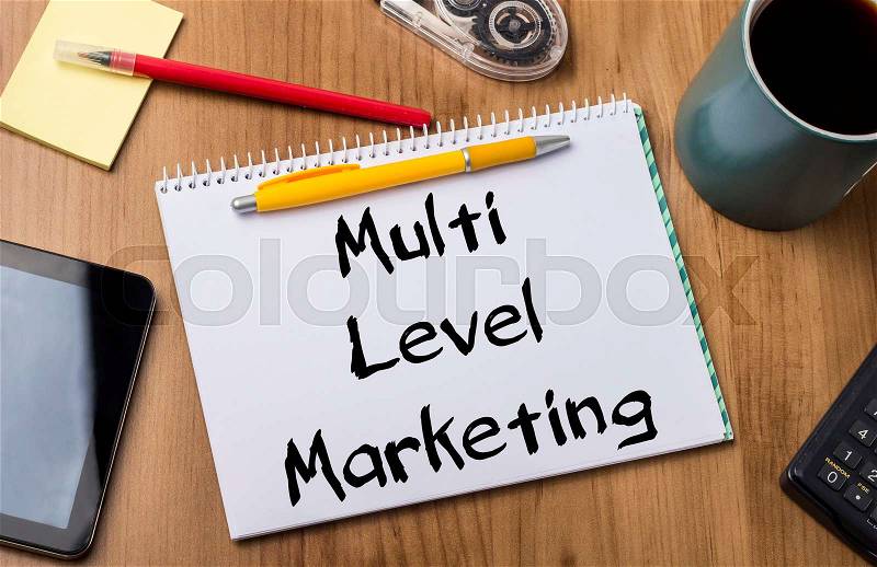 Multi Level Marketing MLM - Note Pad With Text On Wooden Table - with office tools, stock photo