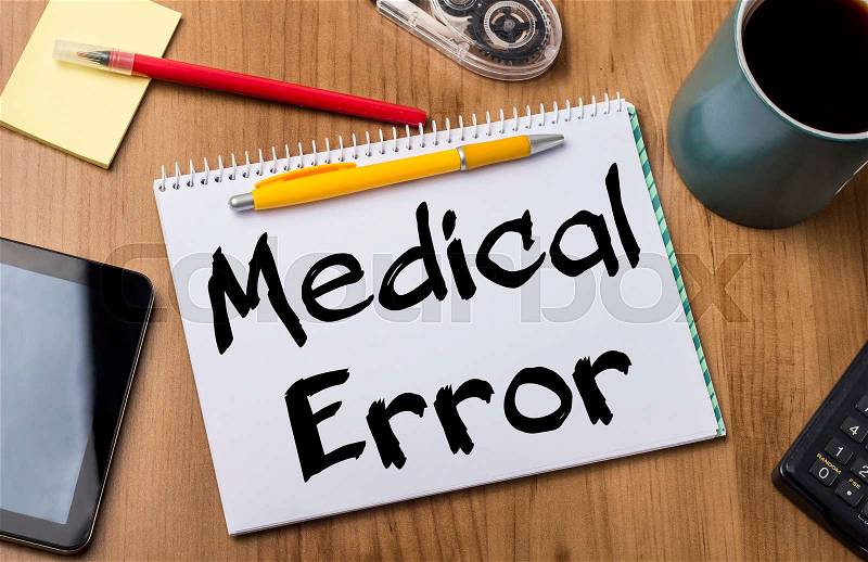 Medical Error - Note Pad With Text On Wooden Table - with office tools, stock photo