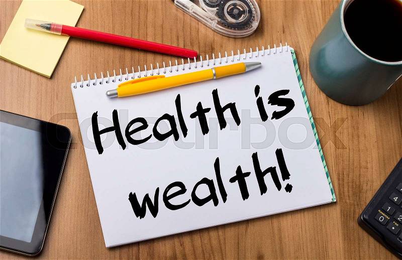Health is wealth! - Note Pad With Text On Wooden Table - with office tools, stock photo