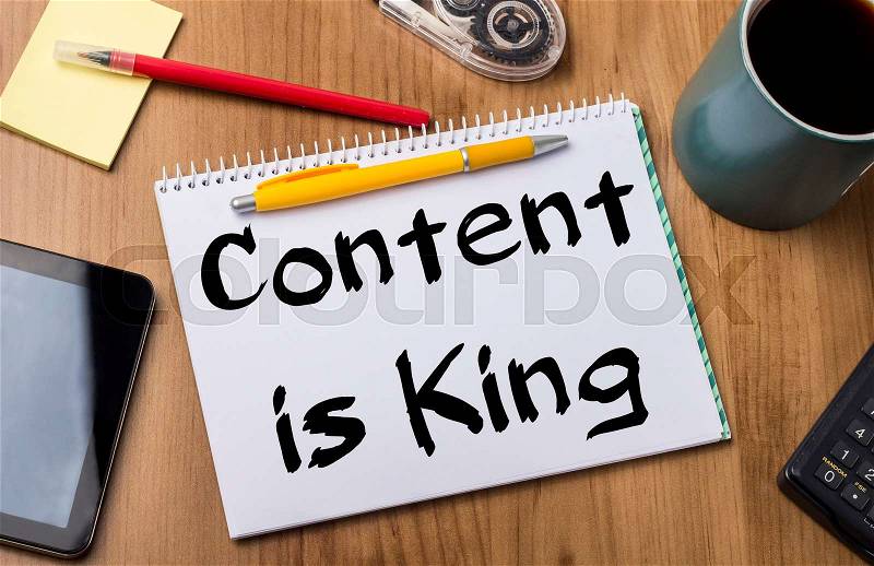 Content is King - Note Pad With Text On Wooden Table - with office tools, stock photo