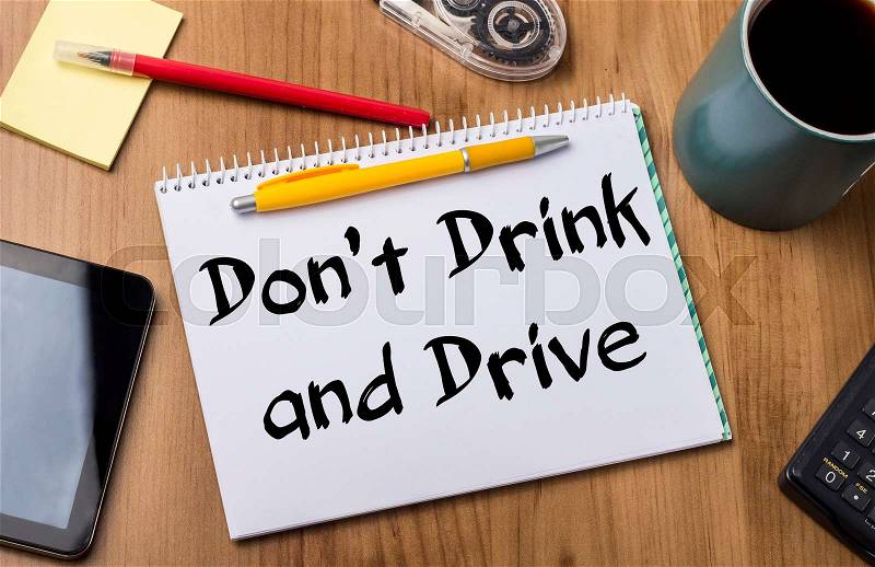 Don’t Drink and Drive - Note Pad With Text On Wooden Table - with office tools, stock photo