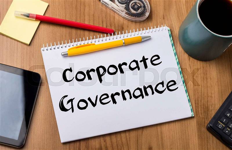 Corporate Governance - Note Pad With Text On Wooden Table - with office tools, stock photo