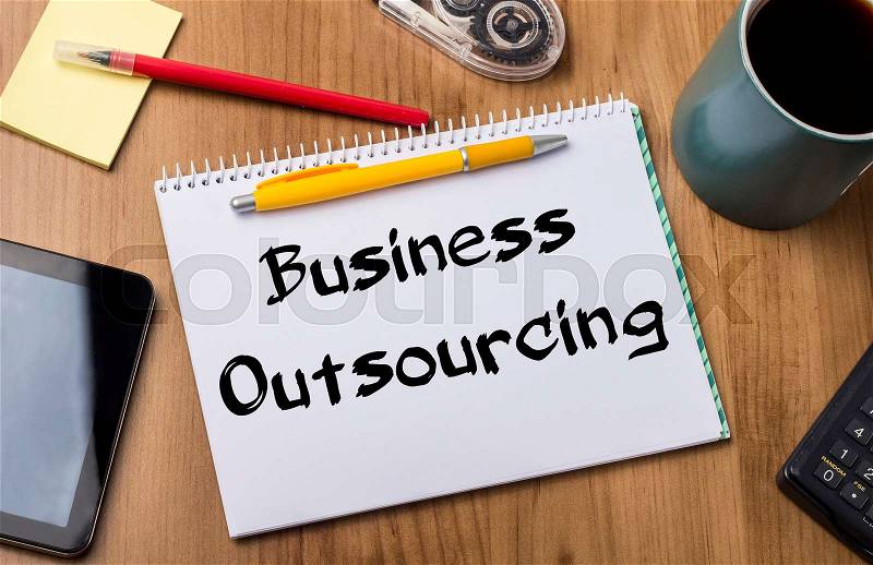 Business Outsourcing - Note Pad With Text On Wooden Table - with office tools, stock photo