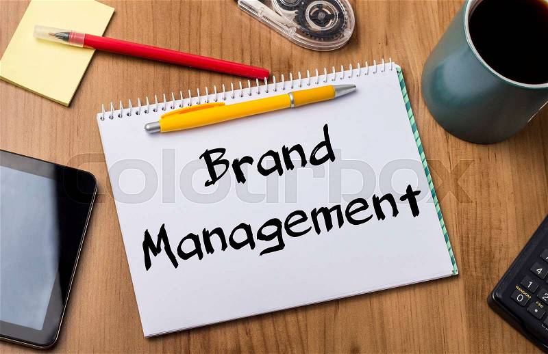 Brand Management - Note Pad With Text On Wooden Table - with office tools, stock photo