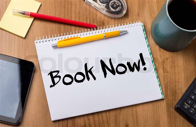 Book Now! - Note Pad With Text On Wooden Table - with office tools, stock photo