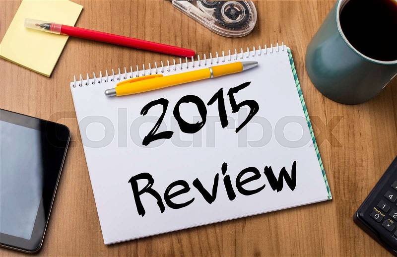 2015 Review - Note Pad With Text On Wooden Table - with office tools, stock photo
