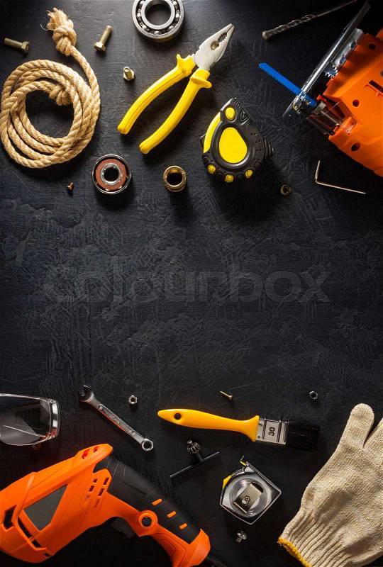 Electric tools and instruments on black background, stock photo