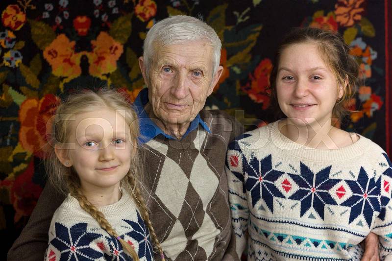 Portrait of smiling senior man and the great-granddaughters , stock photo