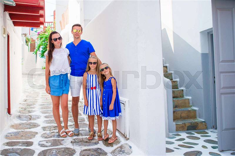 Family vacation in Europe of typical greek traditional village on Mykonos, stock photo