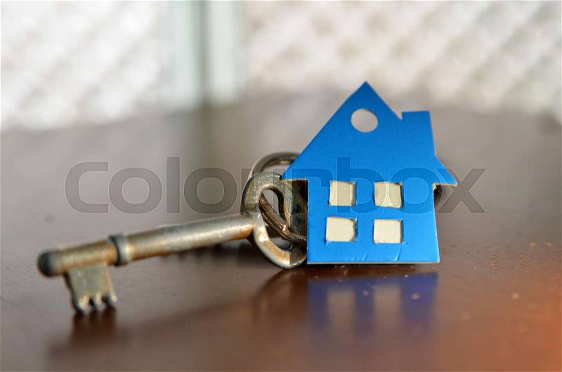 Bunch of keys with house shaped cardboard on a wooden table, stock photo