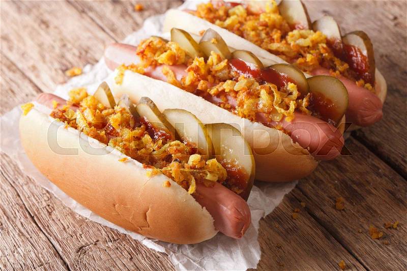 Fresh Danish hot dogs with crispy onions and pickles close up on the table. horizontal , stock photo