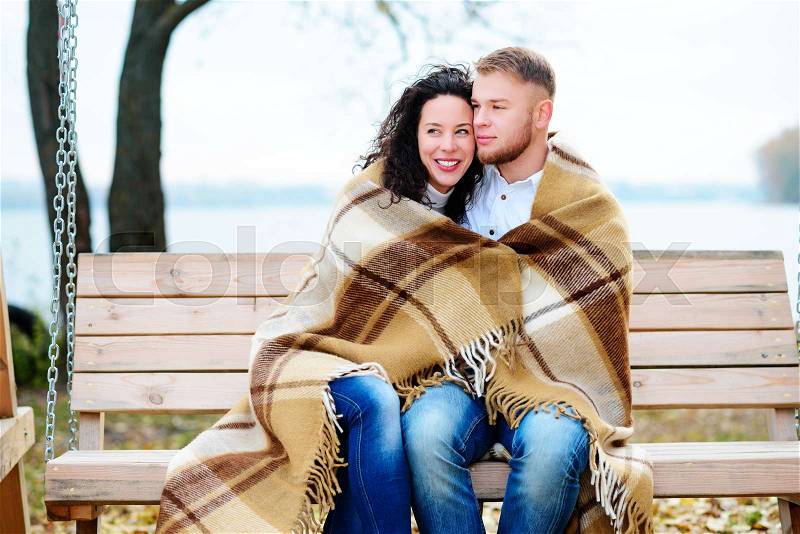 Amorous couple on romantic date on swings outdoor ,autumn, stock photo