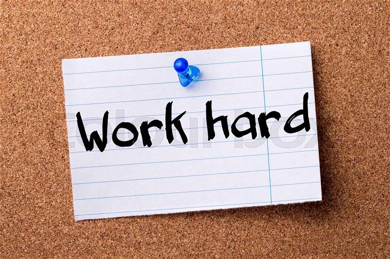 Work hard - teared note paper pinned on bulletin board - horizontal image, stock photo