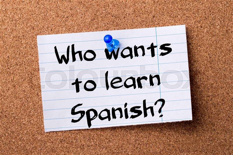 Who wants to learn Spanish? - teared note paper pinned on bulletin board - horizontal image, stock photo